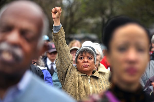 Doreen Wade from Cambridge raises her fist in the air at the Parkman Bandstand on Boston Common on Saturday, April 26, 2025, to commemorate the 60th anniversary of the 1965 Freedom Rally on Boston Common which featured Martin Luther King Jr. She was six years old when she marched with her family in 1965. (John Tlumacki/The Boston Globe via AP)