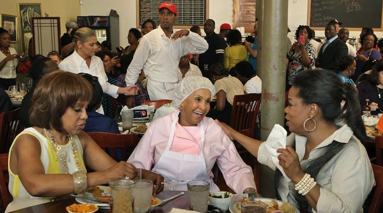 Sweetie Pie’s owner Robbie Montgomery, center, greets Gayle King and Oprah Winfrey at her restaurant, where they ate a fried chicken dinner in St. Louis. (J.B. Forbes/St. Louis Post-Dispatch/TNS)