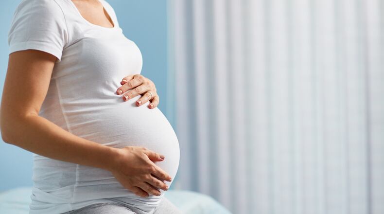 Eight moms who conceived during Hurricane Matthew posed for photos 8 months pregnant.