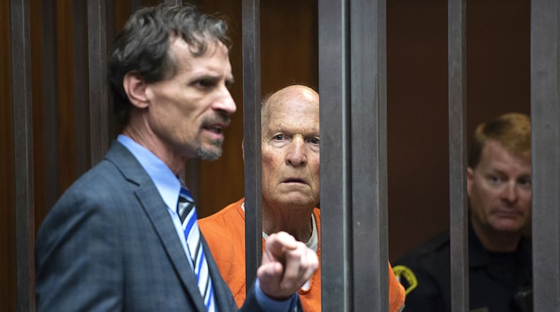 Joseph James DeAngelo Jr., center, listens as his attorney, Joe Cress, speaks in a Sacramento, Calif., courtroom on Tuesday, May 29, 2018, as a judge weighs how much information to release about the arrest of the former police officer accused of being the Golden State Killer. The judge on Friday unsealed the heavily-redacted search warrant and police affidavit that led to DeAngelo's April 24 arrest.