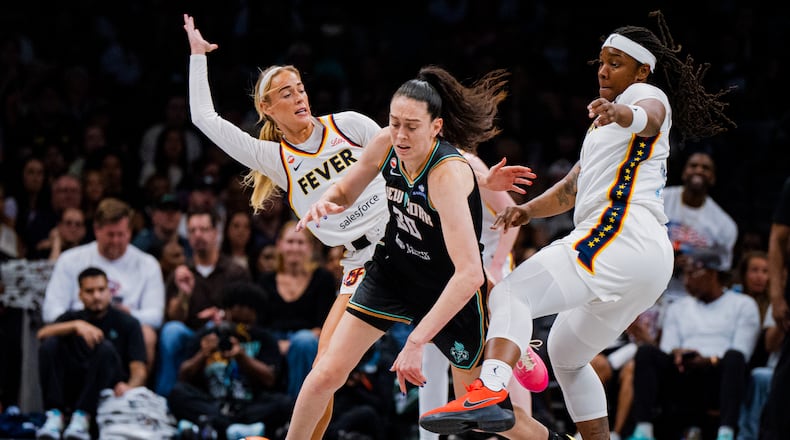 Indiana Fever guard Sophie Cunningham (8) fouls New York Liberty forward Breanna Stewart (30) during the second half of a WNBA basketball game, Saturday, Aug. 22, 2026, in New York. (AP Photo/Angelina Katsanis)