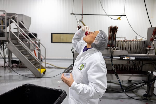 Leslie Zinn, CEO of Arden's Gardens, samples beet juice at the juicing plant in East Point on Tuesday, December 2, 2025. (Arvin Temkar/AJC)