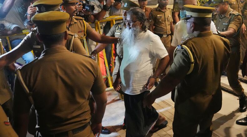 Unidentified men convicted for their involvement in the 2019 Easter bombings are escorted to a prison in Colombo, Wednesday, Sept. 23, 2026. (AP Photo/Eranga Jayawardena)