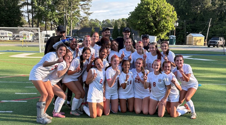 Holy Innocents' players and coaches celebrate their 1-0 victory over Wesleyan in the Class 3A-A Private girls soccer championship on Tuesday, May 12, 2026, at St. Pius X High School. (Chip Saye/AJC)
