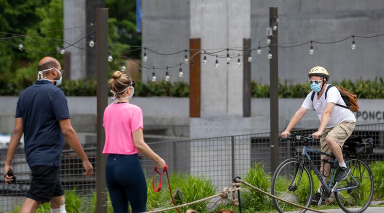 05/04/2020 - Atlanta, Georgia - A bicyclist wears a face mask as he travels along the Atlanta BeltLine in the Old Fourth Ward community, In Sandy Springs, the revenue and permitting office at city hall is closed temporarily after officials learned an employee tested positive for COVID-19. (ALYSSA POINTER / ALYSSA.POINTER@AJC.COM)