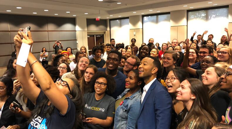 John Legend poses for a selfie with Georgia Tech students during a campaign stop for Democrat Stacey Abrams. Bria Felicien/AJC