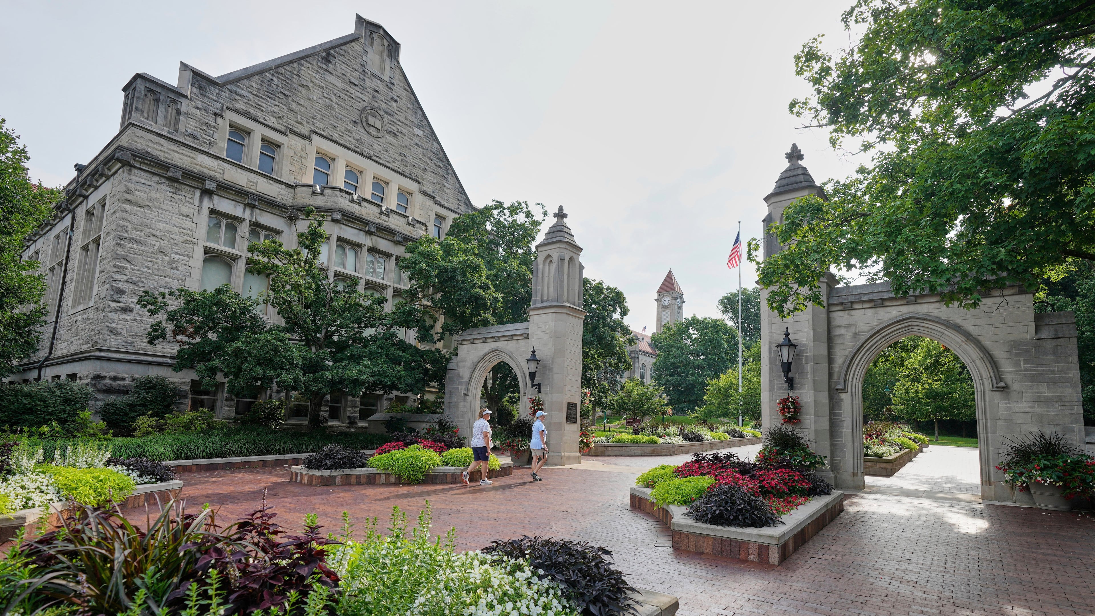 FILE - Guests walk on the campus of Indiana University, Thursday, July 17, 2025, in Bloomington, Ind. (AP Photo/Darron Cummings, File)