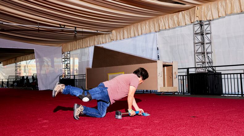 Teams install the red carpet at the Dolby Theater before the Oscars in Los Angeles, on Feb. 21, 2025. Steve Olive, who has worked in the event carpet business for more than three decades, is the man the Academy trusts to get its iconic rug just right. (Jennelle Fong/The New York Times)