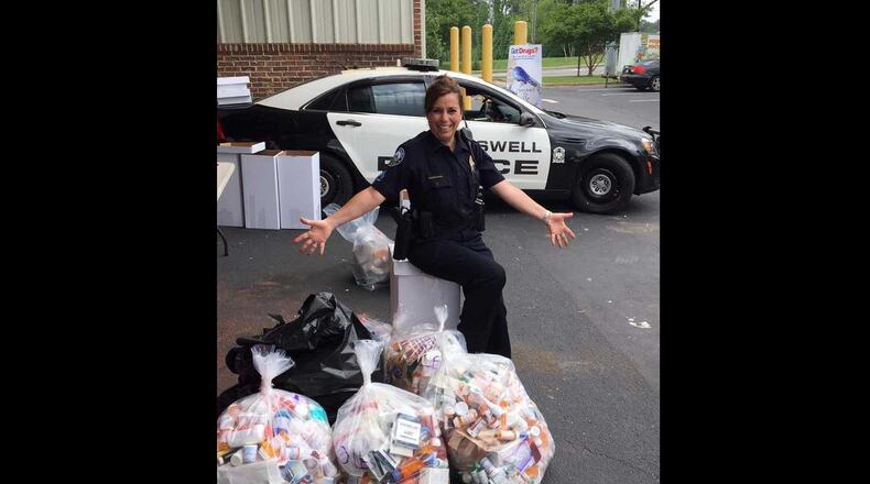 Roswell Police Officer Lisa Holland shown with the 241 pounds of drugs taken by the department on "Drug Take-Back Day."