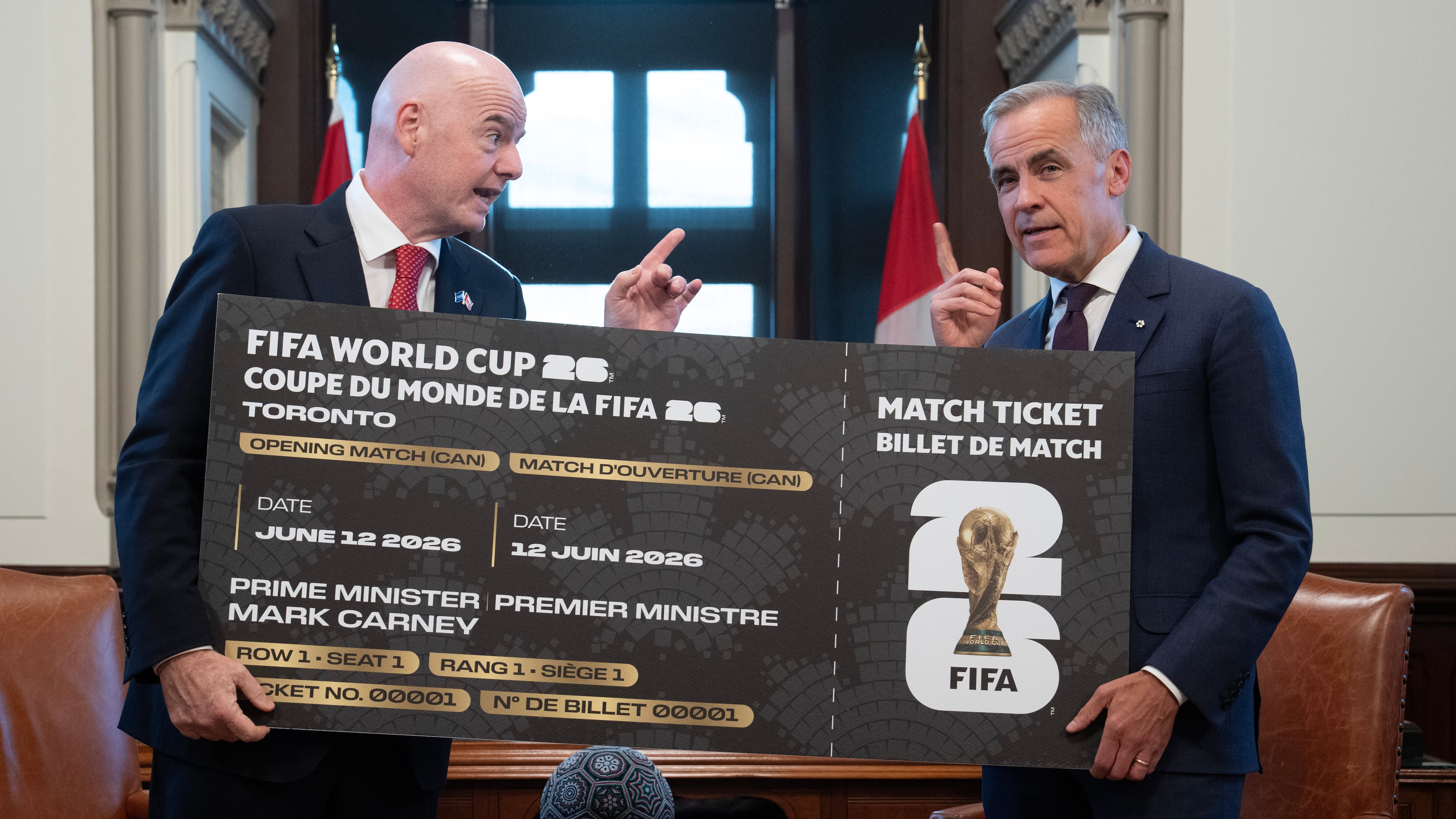 Canada Prime Minister Mark Carney, right, is presented with a novelty World Cup ticket by FIFA President Gianni Infantino on Parliament Hill in Ottawa, Ontario, Friday, Oct. 10, 2025. (Adrian Wyld/The Canadian Press via AP)