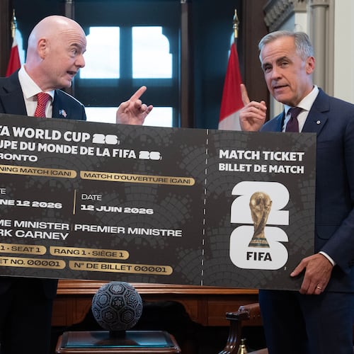 Canada Prime Minister Mark Carney, right, is presented with a novelty World Cup ticket by FIFA President Gianni Infantino on Parliament Hill in Ottawa, Ontario, Friday, Oct. 10, 2025. (Adrian Wyld/The Canadian Press via AP)
