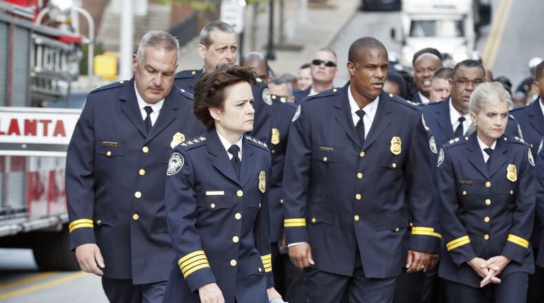 5/8/18 - Atlanta - Police Chief Erika Shields leads police department members into City Hall after a procession from public safety headquarters. The Atlanta Police Department is held its 27th Annual Atlanta Police Memorial Service to pay tribute to the lives of 88 Atlanta police officers killed in the line of duty. Arthur Blank was the keynote speaker. The event included a procession of officers from the public safety building to city hall. Bob Andres / bandres@ajc.com