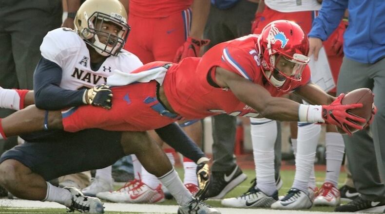 SMU receiver Courtland Sutton (16) lays out to get extra yardage after catching a second-quarter pass as Navy cornerback Jarid Ryan (9) defends at Ford Stadium in Dallas on Saturday, Nov. 26, 2016. Sutton is back at SMU this season. (Louis DeLuca/Dallas Morning News/TNS)