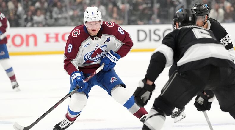 Colorado Avalanche's Cale Makar (8) brings the puck across the blue line against Los Angeles Kings during the first period of Game 4 in the first round of an NHL hockey Stanley Cup playoff series Sunday, April 26, 2026, in Los Angeles. (AP Photo/Scott Strazzante)