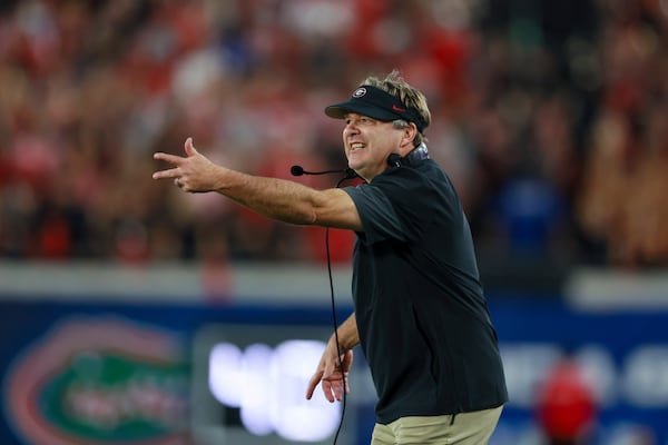 Georgia coach Kirby Smart — pictured reacting to a call in the game against Florida on Saturday, Nov. 1, 2025 — said quarterback Gunner Stockton made the right decision by kneeling to win the game against the Gators. In an earlier game against Auburn, Stockton scored a late touchdown to give the Bulldogs a bigger lead, but the play also gave the Tigers the ball with an outside chance to come back to win. (Jason Getz/AJC)