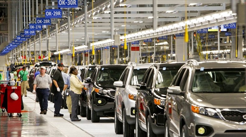 Nearly completed cars come down the assembly line at the Kia plant near West Point.