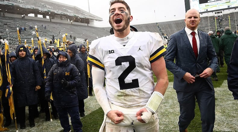 Shea Patterson of the Michigan Wolverines leaves the field after a 21-7 win over the Michigan State Spartans at Spartan Stadium on October 20, 2018 in East Lansing, Michigan. (Photo by Gregory Shamus/Getty Images)