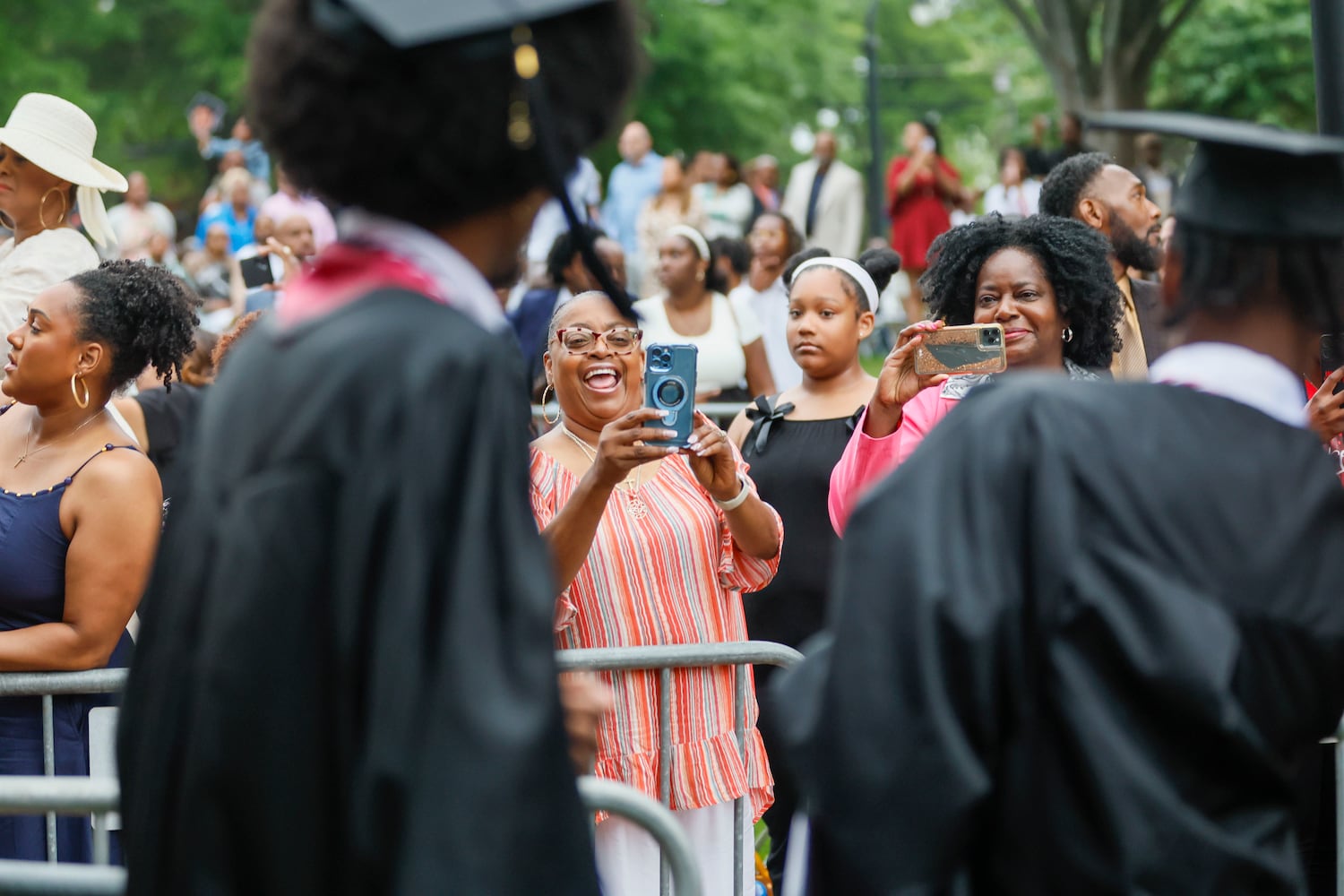 A family member wears a headband as they watch the graduate enter the ceremony during Morehouse College's 141st Commencement Ceremony on Sunday, May 18, 2025.
(Miguel Martinez/ AJC)