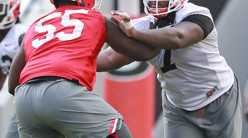 Georgia defensive lineman Jay Hayes (center) blocks offensive lineman Trey Hill during team practice at Fan Day on Saturday, August 4, 2018, in Athens. Curtis Compton/ccompton@ajc.com