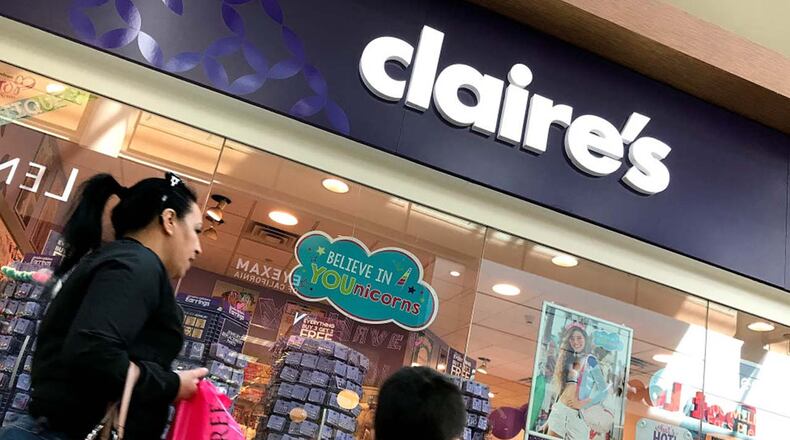 People walk by a Claire's store at the Northgate Mall on March 19, 2018 in San Rafael, California. The teen jewelry chain store is recalling three types of makeup over asbestos contamination fears.