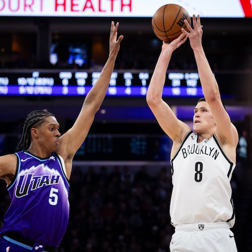 Brooklyn Nets guard Egor Dëmin (8) looks to shoot over Utah Jazz forward Cody Williams (5) during the first half of an NBA basketball game, Friday, Jan. 30, 2026, in Salt Lake City. (AP Photo/Anna Fuder)