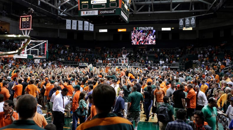 Miami fans rush the court to celebrate after defeating Duke 90-63 in an NCAA college basketball game in Coral Gables, Fla., Wednesday, Jan. 23, 2013. (AP Photo/Alan Diaz)
