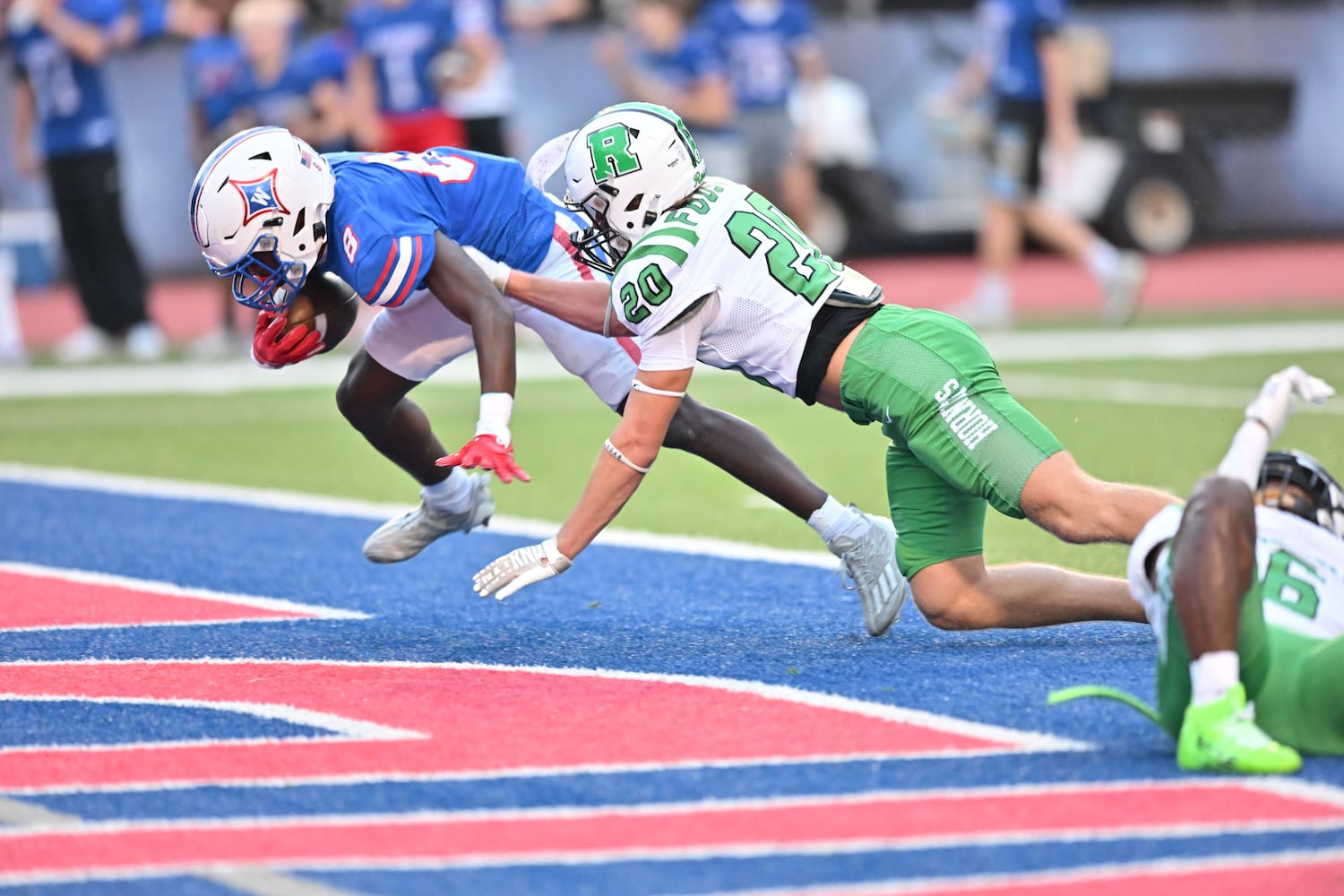 Walton running back Noriega Thompson (8) scores a touchdown against Roswell defensive back Ian Foust (20) during the first half of a game Friday, August 29, 2025 at Walton High School. (Daniel Varnado/For the Atlanta Journal-Constitution)
