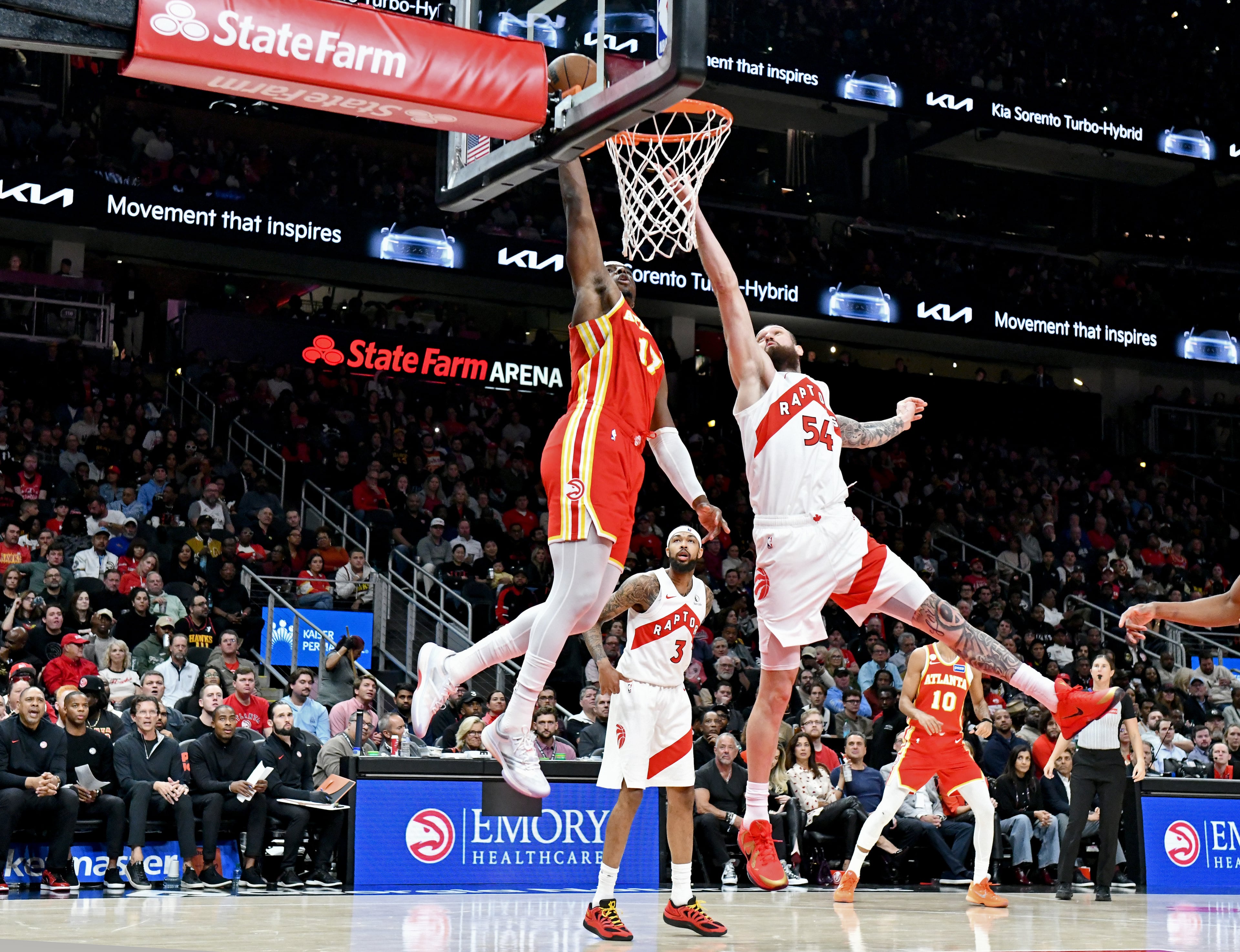 Atlanta Hawks forward/center Onyeka Okongwu (17) dunks the ball against Toronto Raptors forward/center Sandro Mamukelashvili (54) during the second half in the home opener at State Farm Arena, Thursday, October 22, 2025, in Atlanta. Toronto Raptors won 138-118 over Atlanta Hawks. (Hyosub Shin / AJC)