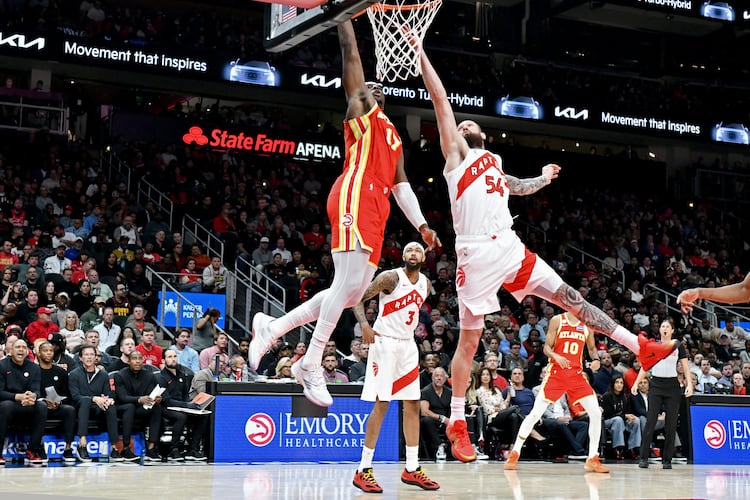 Atlanta Hawks forward/center Onyeka Okongwu (17) dunks the ball against Toronto Raptors forward/center Sandro Mamukelashvili (54) during the second half in the home opener at State Farm Arena, Thursday, October 22, 2025, in Atlanta. Toronto Raptors won 138-118 over Atlanta Hawks. (Hyosub Shin / AJC)