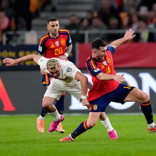 Turkey's Barış Alper Yılmaz fights for the ball against Spain's Aymeric Laporte during the 2026 World Cup qualifier Nov. 18. (Jose Breton/AP)