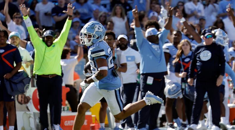 North Carolina defensive back Alijah Huzzie (28) returns a punt back for a touchdown against Georgia Tech during the second half of an NCAA college football game, Saturday, Oct. 12, 2024, in Chapel Hill, N.C. (AP Photo/Chris Seward)
