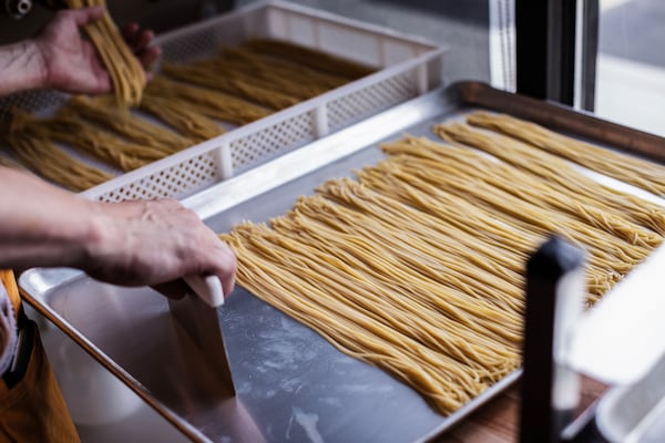 A tray of fresh pasta laid out to dry.