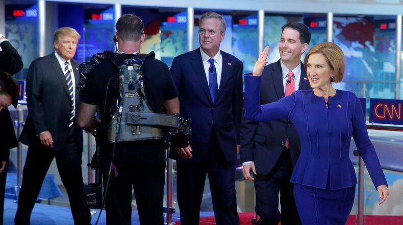 Republican presidential candidate, businesswoman Carly Fiorina, right, leads fellow candidates Scott Walker, second from right, Jeb Bush, center, and Donald Trump as they take the stage prior to the CNN Republican presidential debate at the Ronald Reagan Presidential Library and Museum on Wednesday, Sept. 16, 2015, in Simi Valley, Calif. (AP Photo/Chris Carlson)