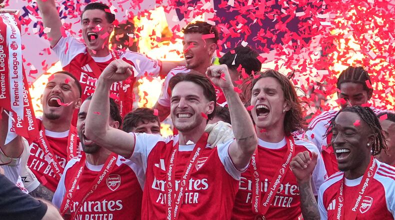 Arsenal players celebrate their Premier League title with the trophy after the English Premier League soccer match between Crystal Palace and Arsenal in London, England, Sunday, May 24, 2026. (AP Photo/Kin Cheung)