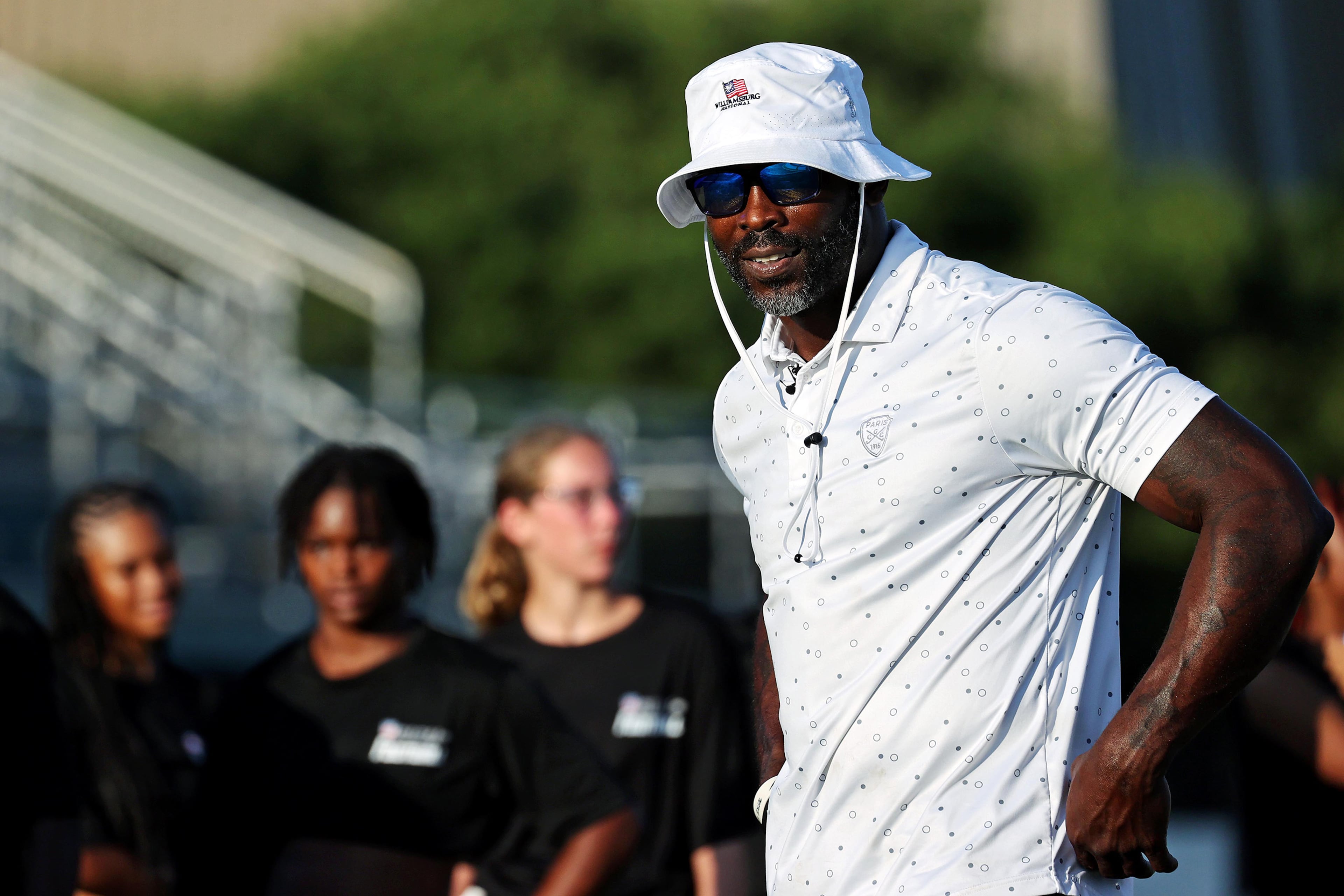 Former NFL star and four-time Pro Bowler Michael Vick looks on during the Second Annual Girls on the Gridiron Flag Football Clinic at Dick Price Stadium in Norfolk, Virginia, July 21, 2024. (Peter Casey/The Virginian-Pilot/TNS)