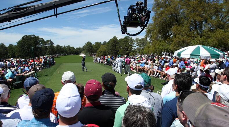 Followed by a huge gallery and broadcast TV camera, Tiger Woods tees off on #1 during the third round in the Masters Tournament on Saturday April 13 2013.