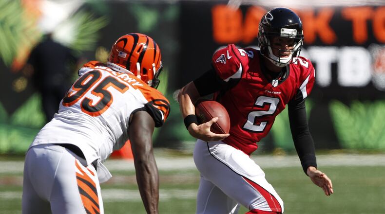 Falcons quarterback Matt Ryan (2) is pursued by Cincinnati Bengals defensive end Wallace Gilberry (95) in the second half Sept. 14 in Cincinnati. (AP Photo/Frank Victores)