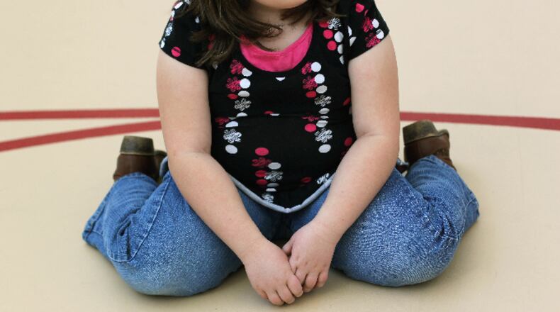 A child sits on the gym floor during the Shapedown program for overweight adolescents and children on November 13, 2010 in Aurora, Colorado.