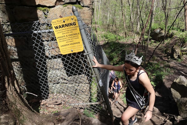 West Virginia Coal Festival teen beauty pageant winner Ava Johnson, 16, explores the abandoned Kay Moor mine complex in the New River Gorge National Park and Preserve near Fayetteville, W.Va., Thursday, April 17, 2025, (AP Photo/Leah Willingham)
