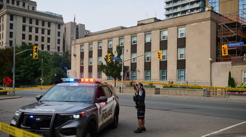 Police work the scene of an early morning shooting outside the US Consulate in Toronto, on Monday, July 27, 2026. (Sammy Kogan/The Canadian Press via AP)