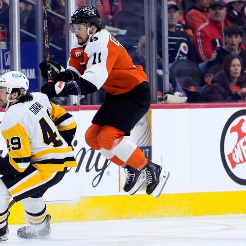 Philadelphia Flyers' Travis Konecny, right, leaps past Pittsburgh Penguins' Samuel Girard during the second period of Game 6 in the first round of the NHL hockey Stanley Cup playoffs series Wednesday, April 29, 2026, in Philadelphia. (AP Photo/Matt Slocum)
