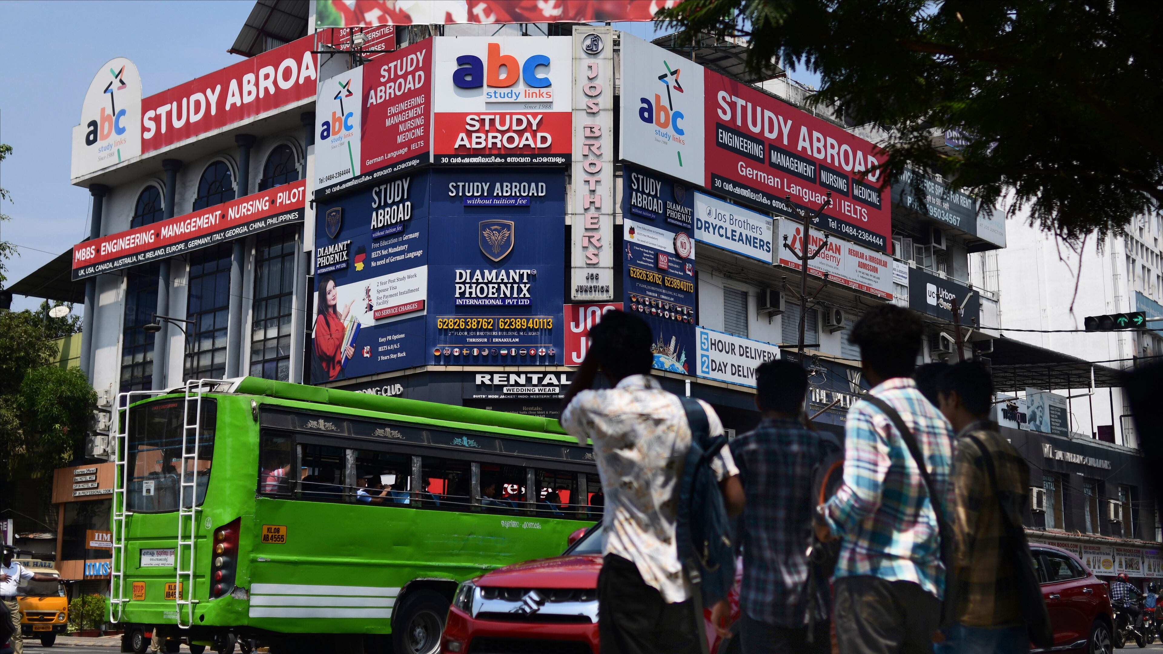 FILE - Sign boards of various educational consultants that attract youth to study abroad cover the façade of a building in Kochi, Kerala state, India, March 7, 2023. (AP Photo/ R S Iyer, File)