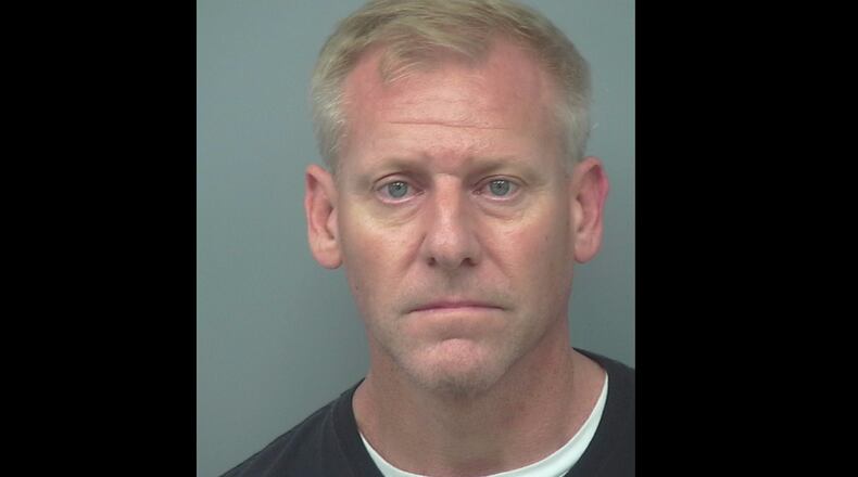 Richard LePage, a DeKalb County police officer, was charged with aggravated assault. He allegedly held a gun to a neighbor's head and threatened to kill him.