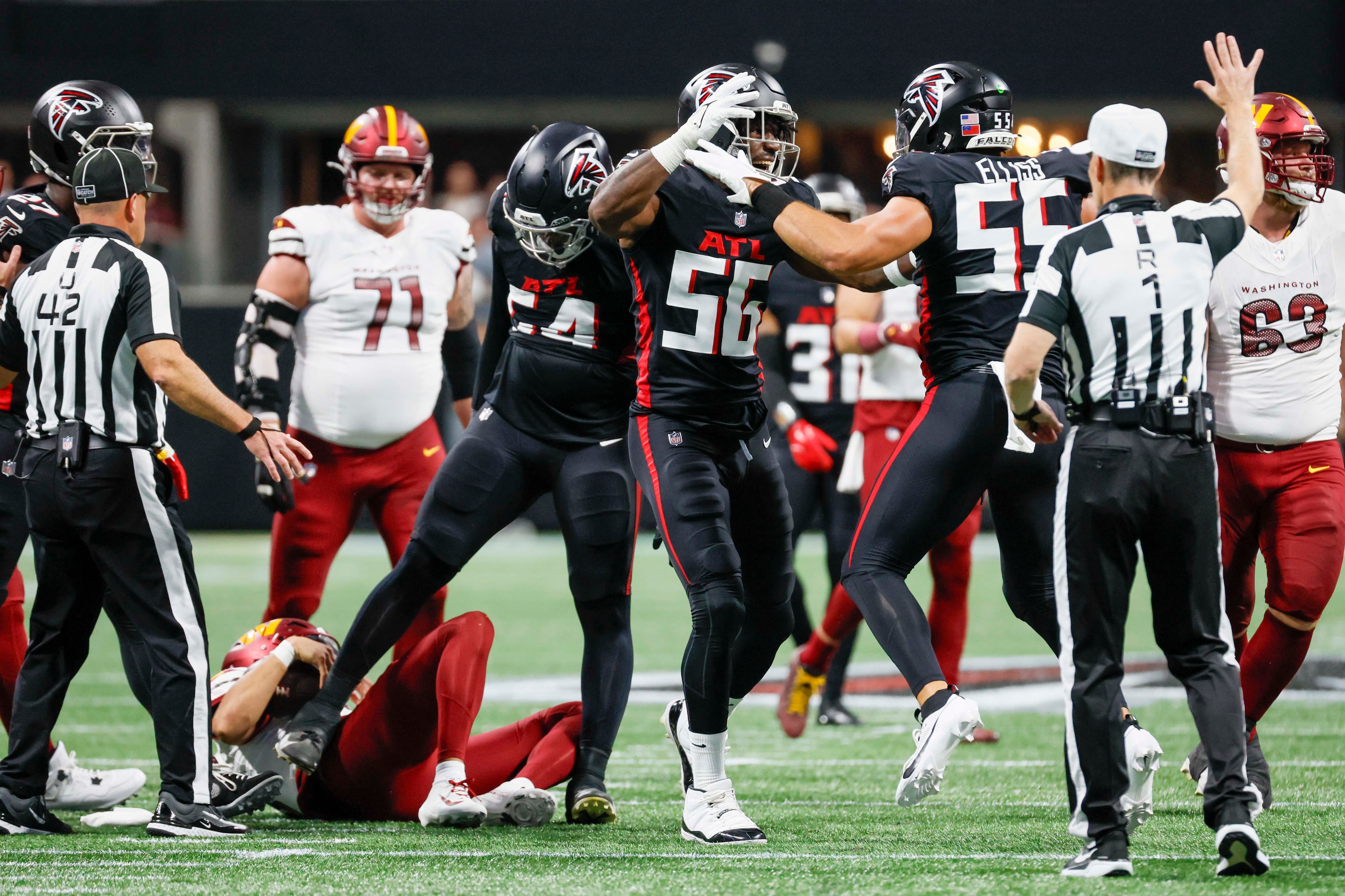 Atlanta Falcons linebacker Kaden Elliss (right) and Falcons defensive end Leonard Floyd celebrate after a sack during the second half of an NFL game at Mercedes-Benz Stadium in Atlanta on Sunday, September 28, 2025. (Miguel Martinez/AJC)