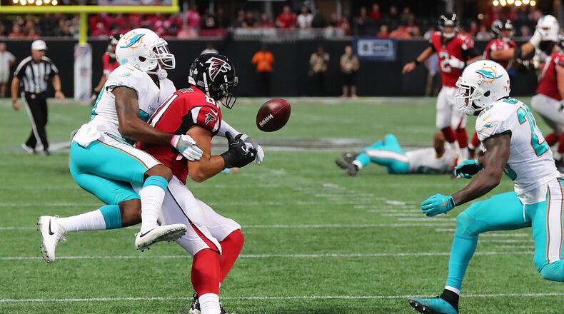 October 15, 2017 Atlanta: Miami Dolphins cornerback Cordrea Tankersley hits Atlanta Falcons tight end Austin Hooper knocking the ball loose for a interception by safety Reshad Jones (right) on a pass from Matt Ryan during the final minute of the game to beat the Falcons 20-17 in a NFL football game on Sunday, October 15, 2017, in Atlanta. Curtis Compton/ccompton@ajc.com