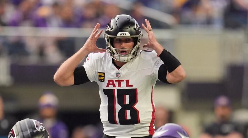 Atlanta Falcons quarterback Kirk Cousins (18) calls out plays during the first half of an NFL football game against the Minnesota Vikings, Sunday, Dec. 8, 2024, in Minneapolis. (AP Photo/Abbie Parr)