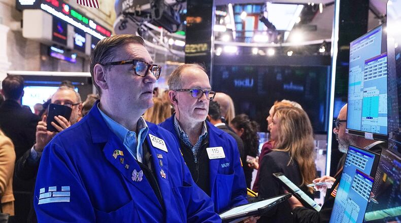Specialist Patrick King, left, and trader Mark Puetzer work on the floor of the New York Stock Exchange, Wednesday, Jan. 28, 2026. (AP Photo/Richard Drew)