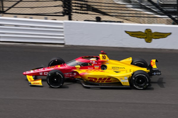 Alex Palou, of Spain, drives into the first turn during practice for the Indianapolis 500 auto race at the Indianapolis Motor Speedway in Indianapolis, Monday, May 19, 2025. (AP Photo/Michael Conroy)