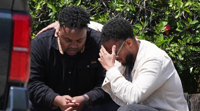 Two men embrace at the scene of a shooting outside the Islamic Center of San Diego Monday, May 18, 2026, in San Diego. (AP Photo/Gregory Bull)