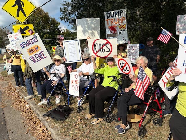 To protest Trump administration policies, "The Walker Brigade" lined Clairmont Road on Saturday afternoon. 